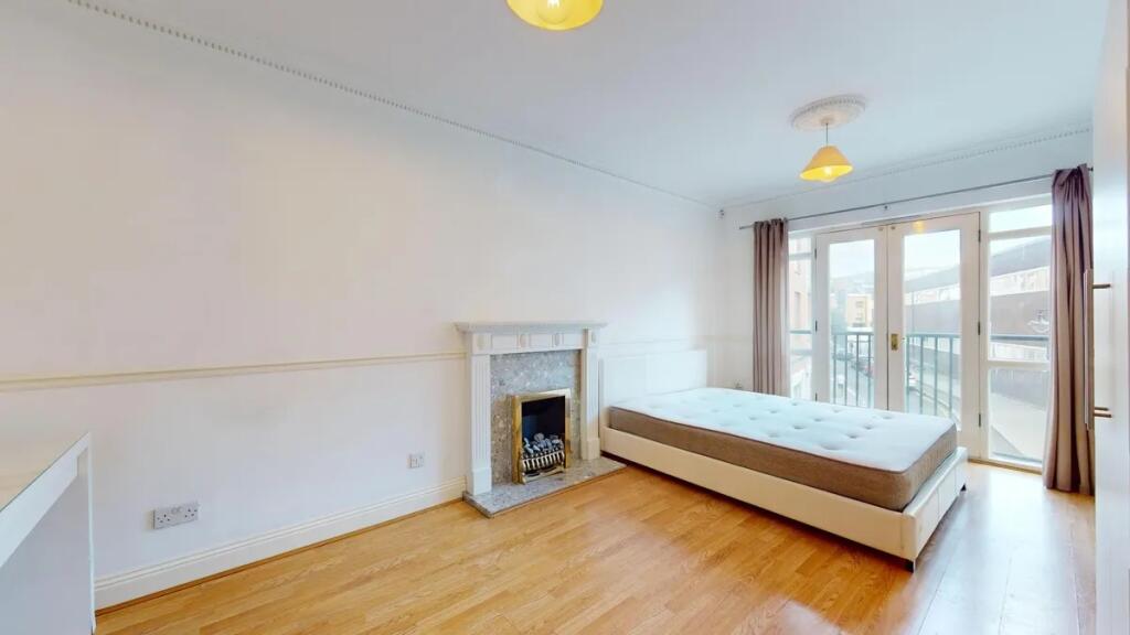 A bright and spacious master bedroom featuring ...