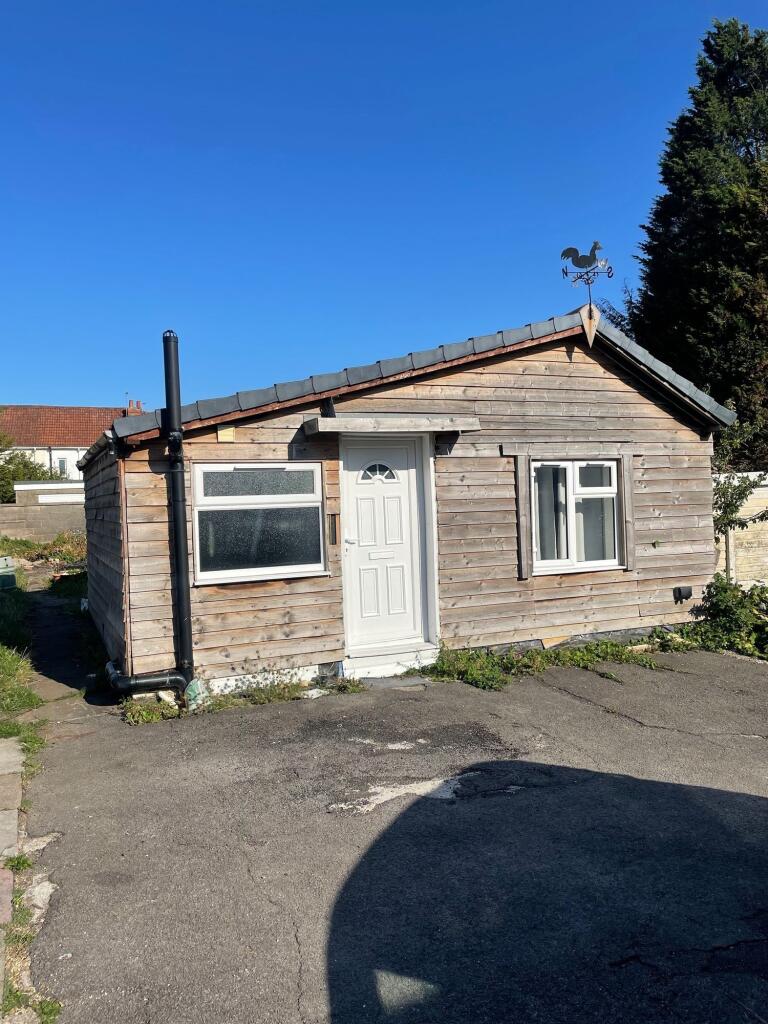 Charming wooden exterior of a single-storey pro...