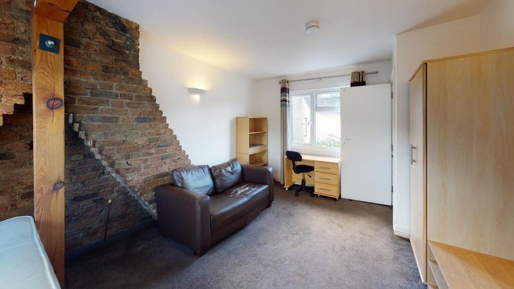 A cozy living room featuring a comfortable leat...