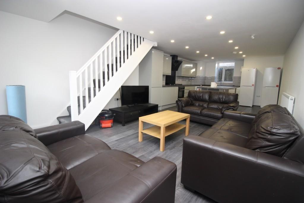 A spacious, modern living room featuring multip...