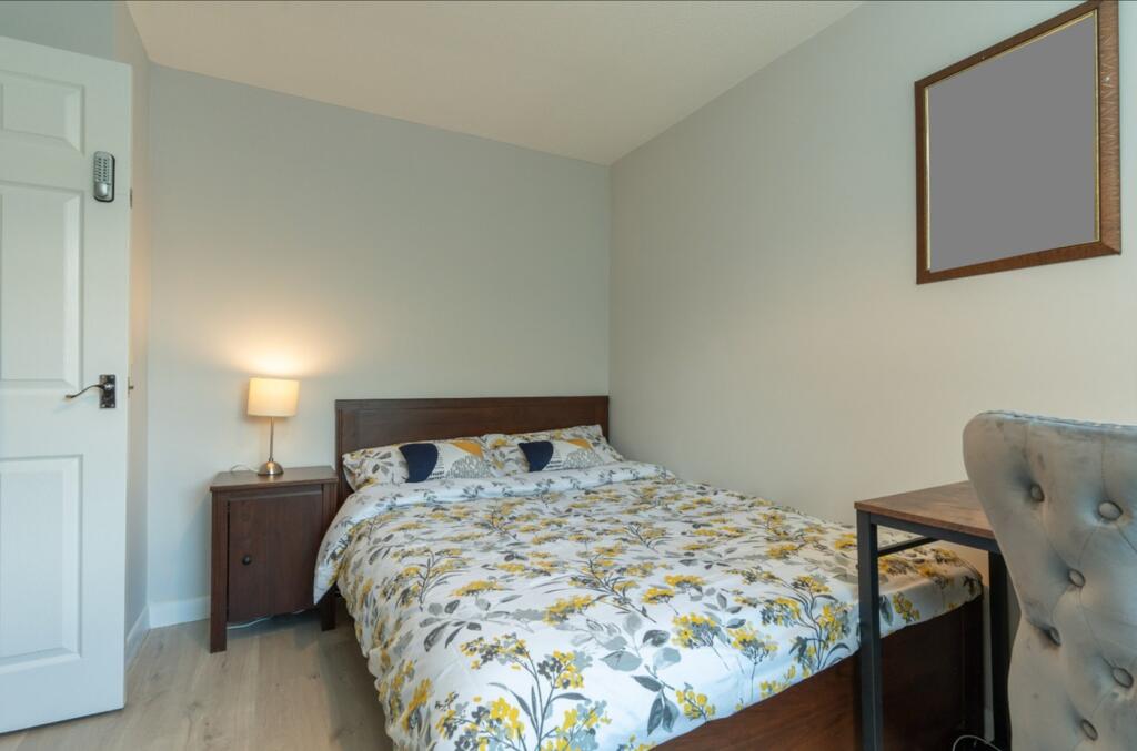 A bright and inviting double bedroom featuring ...