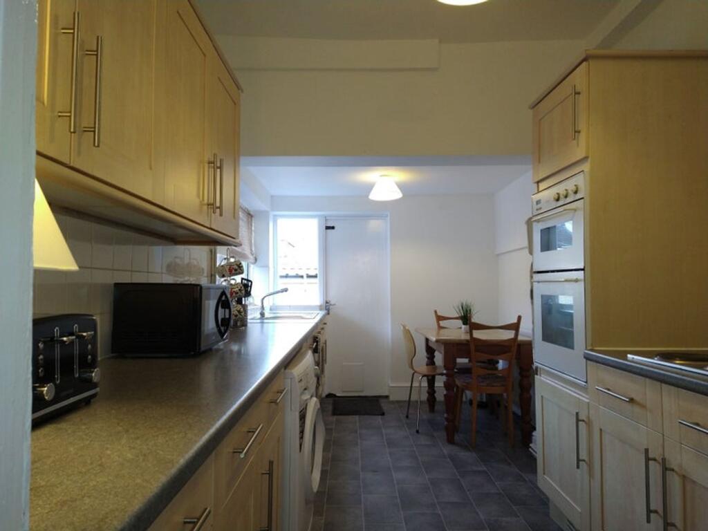 A well-appointed kitchen featuring modern cabin...