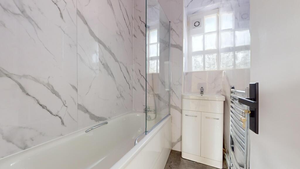A sleek and modern bathroom suite featuring a s...