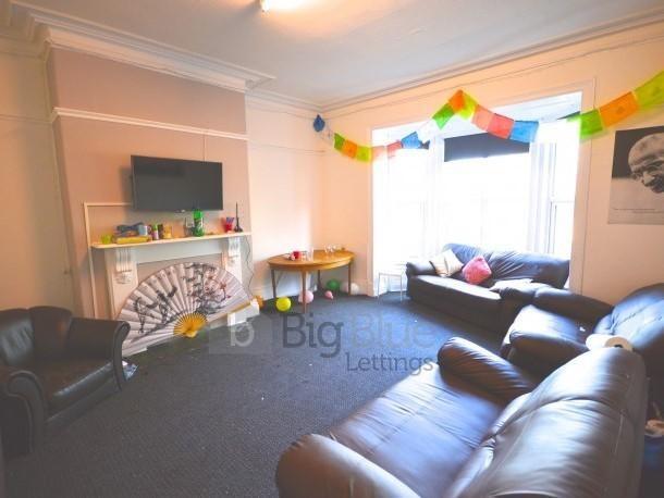 A comfortable living room featuring leather sof...