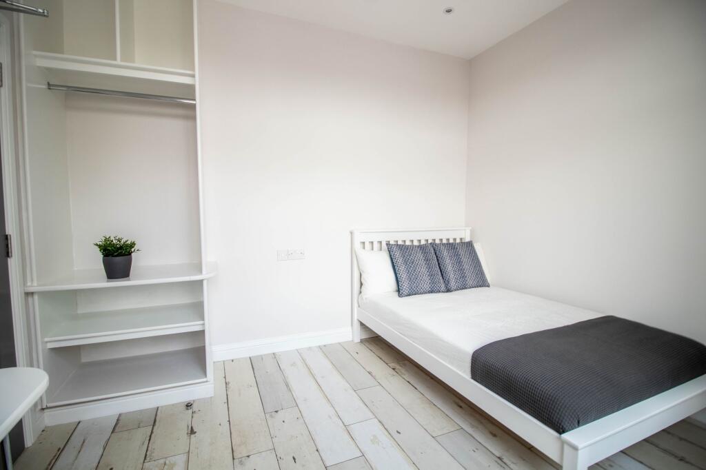 Bright and modern double bedroom featuring a wh...