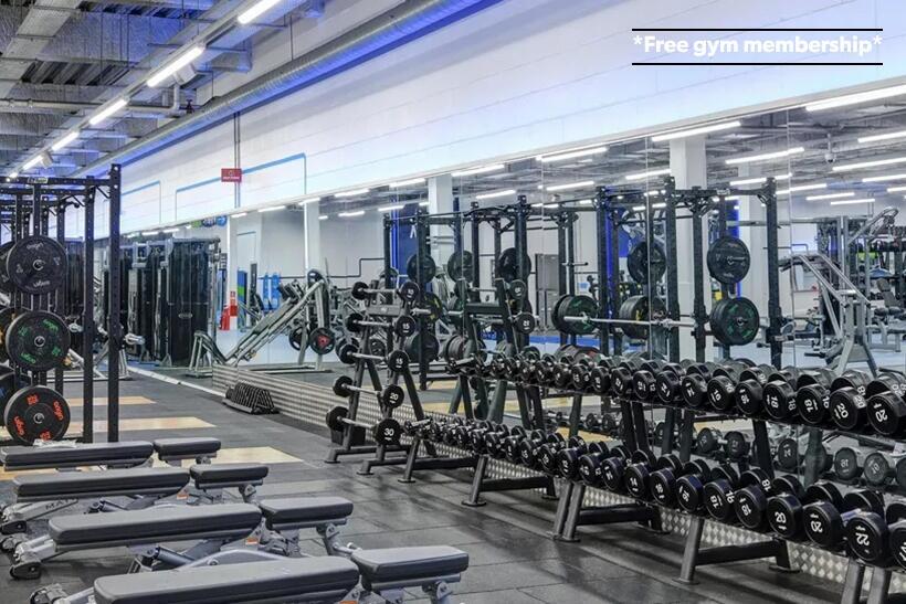 A spacious and well-equipped modern gym with a ...