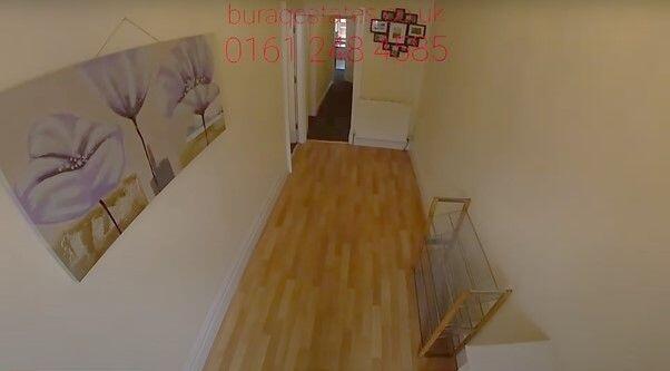 Bright, well-kept hallway with warm wood-effect...
