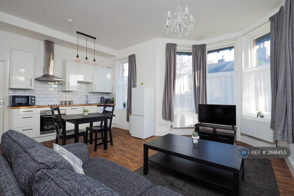 Sofa Is Forward With More Furniture Behind It