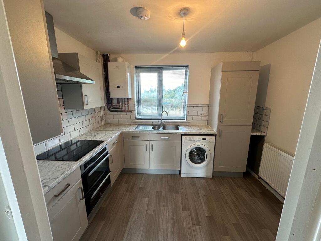 A clean and modern kitchen featuring ample coun...