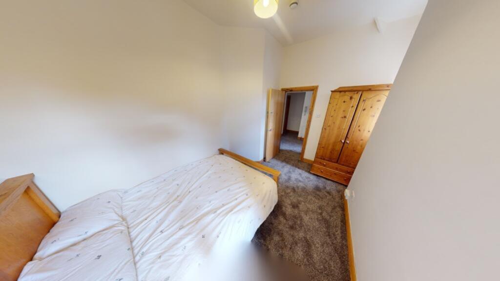 A cozy and inviting double bedroom with ample n...