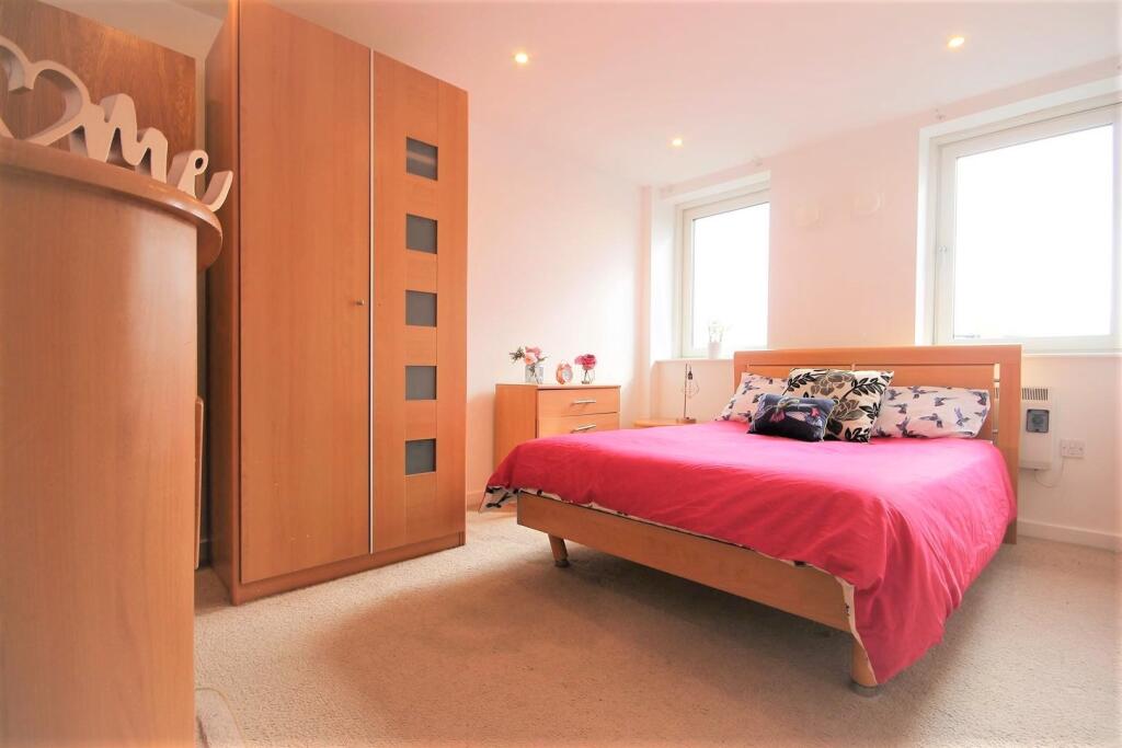 A bright and welcoming double bedroom featuring...