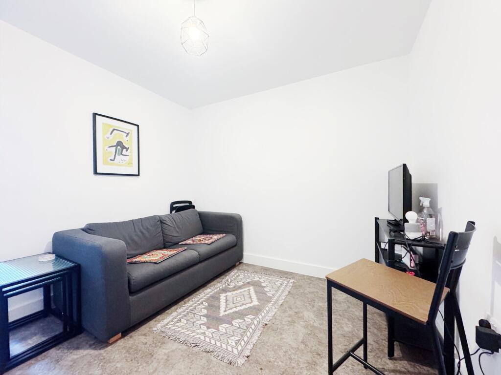 Bright, minimal living room with a comfortable ...