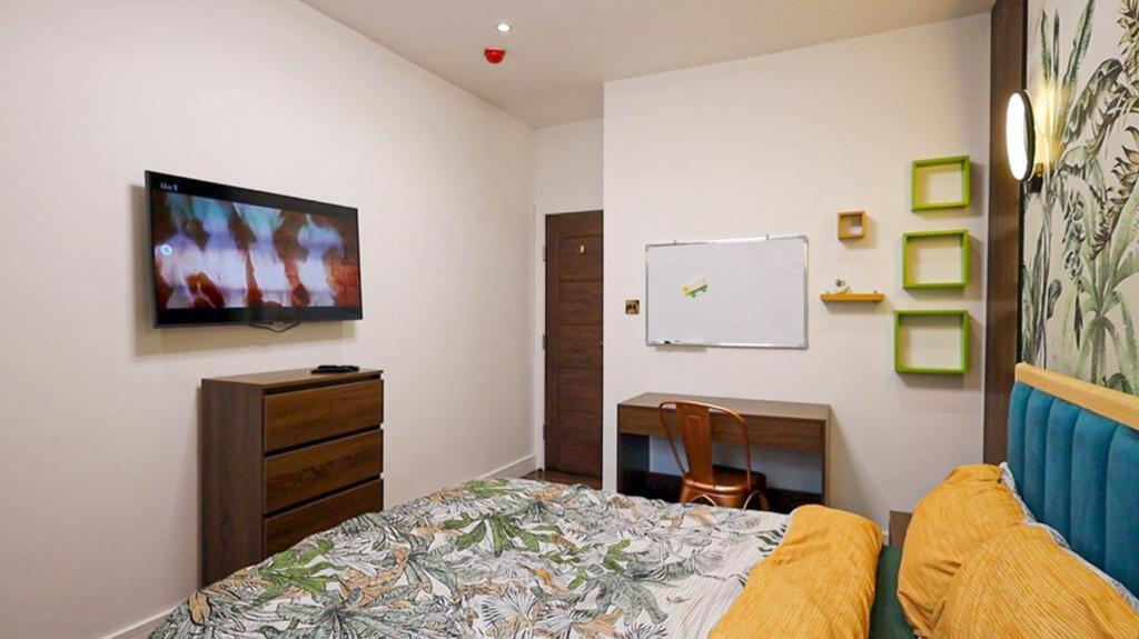 A bright and inviting double bedroom featuring ...