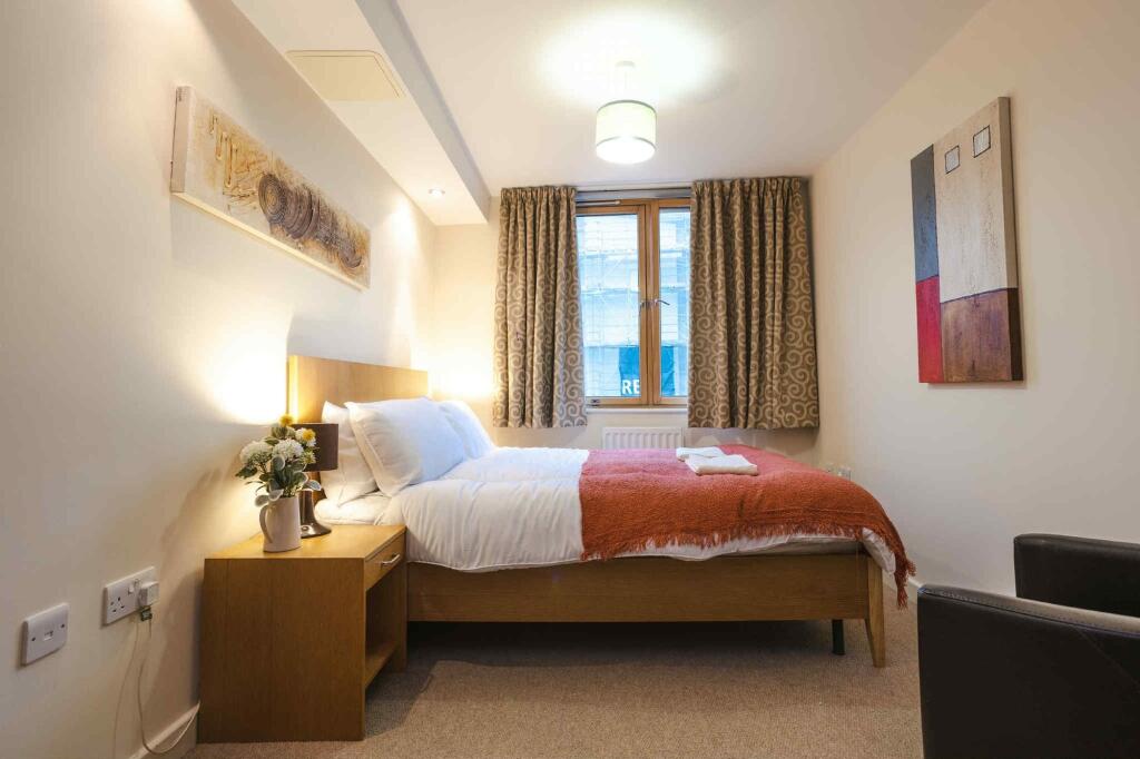 Bright and cozy double bedroom featuring a comf...