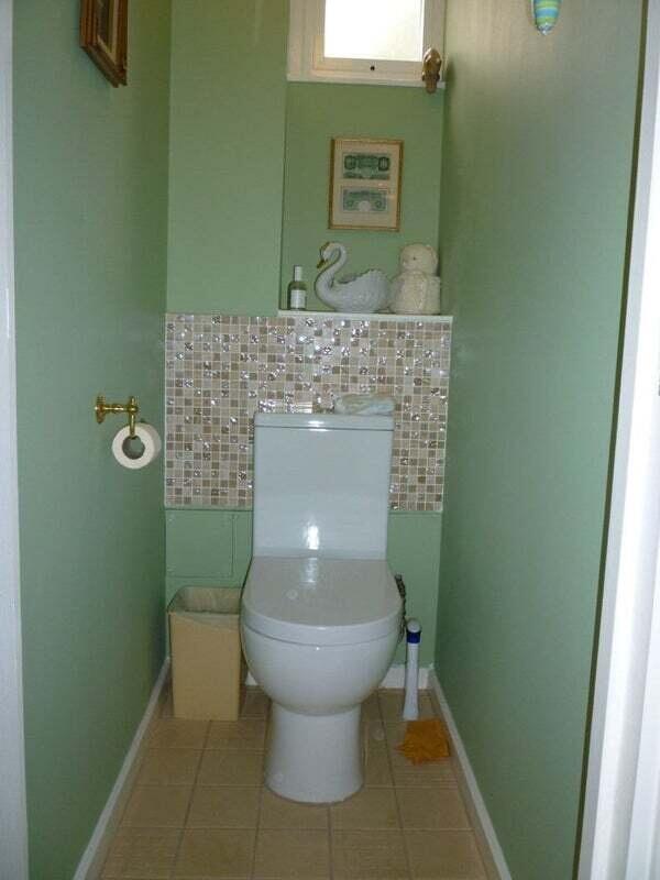 A compact, clean bathroom featuring a white toi...