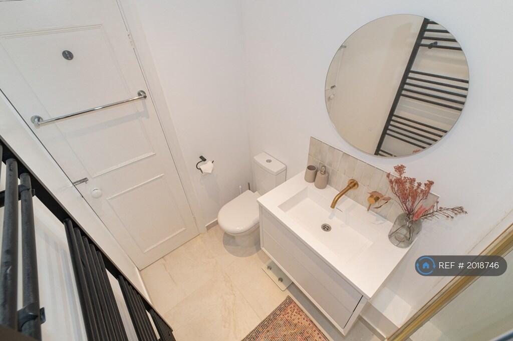 Bathroom With Basin And Round Mirror 