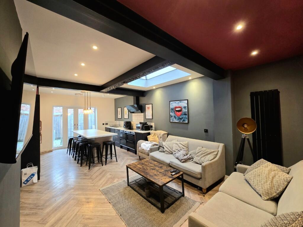 A spacious, modern living room with ample seati...