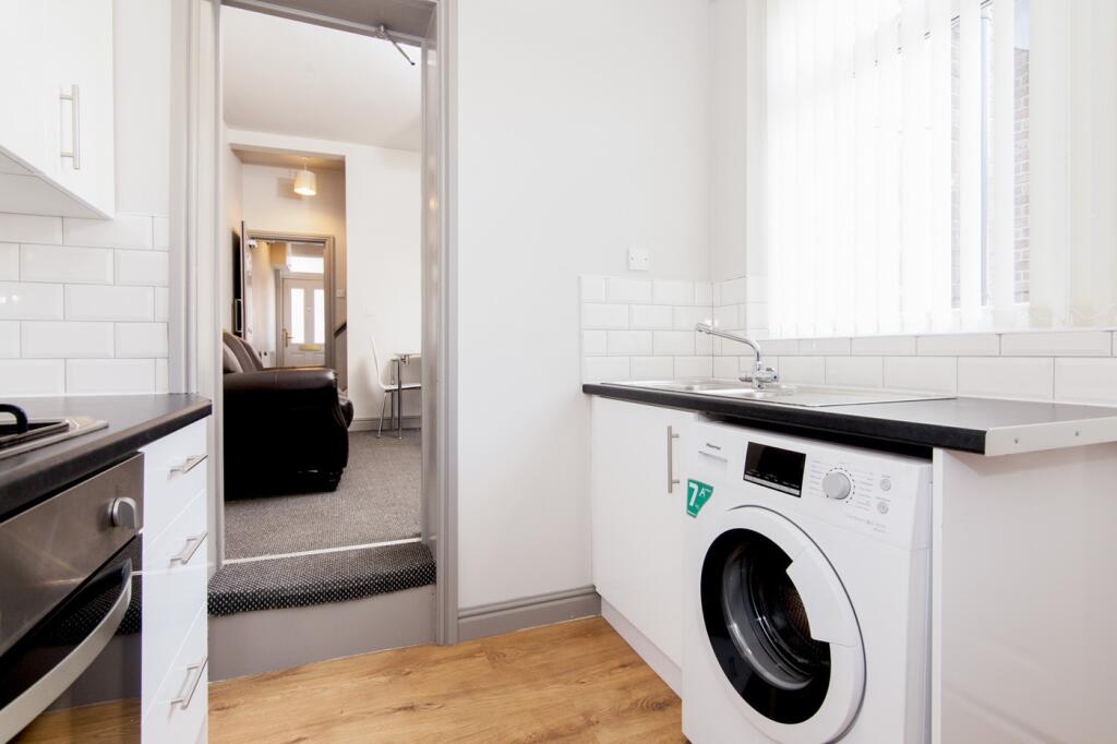 A bright and clean kitchenette equipped with mo...