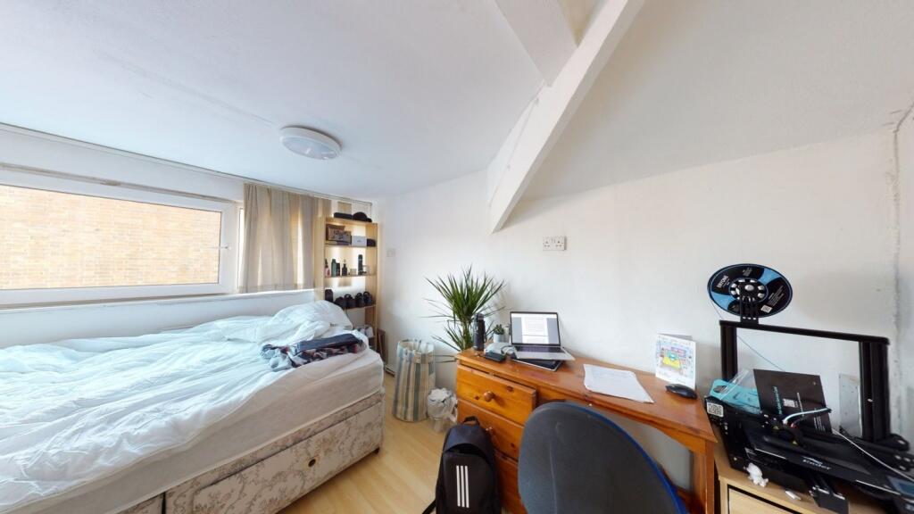 Bright double bedroom featuring a comfortable b...