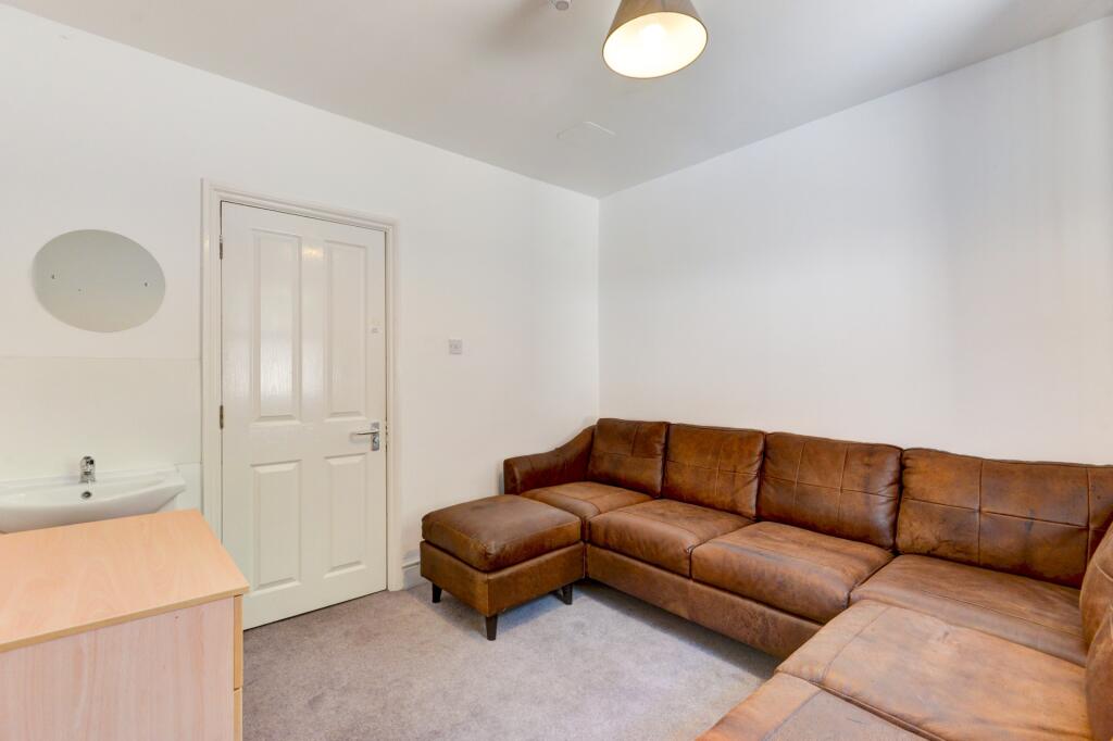 A cozy communal lounge featuring a comfortable ...