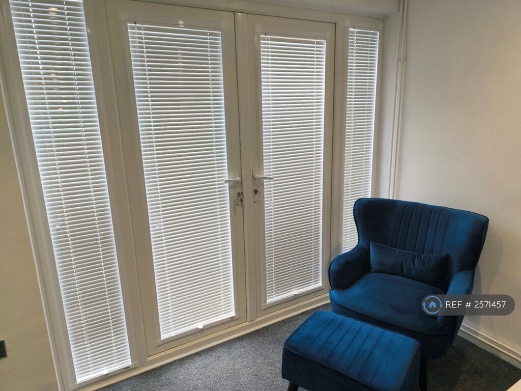 Arm Chair And Footstool In Lounge