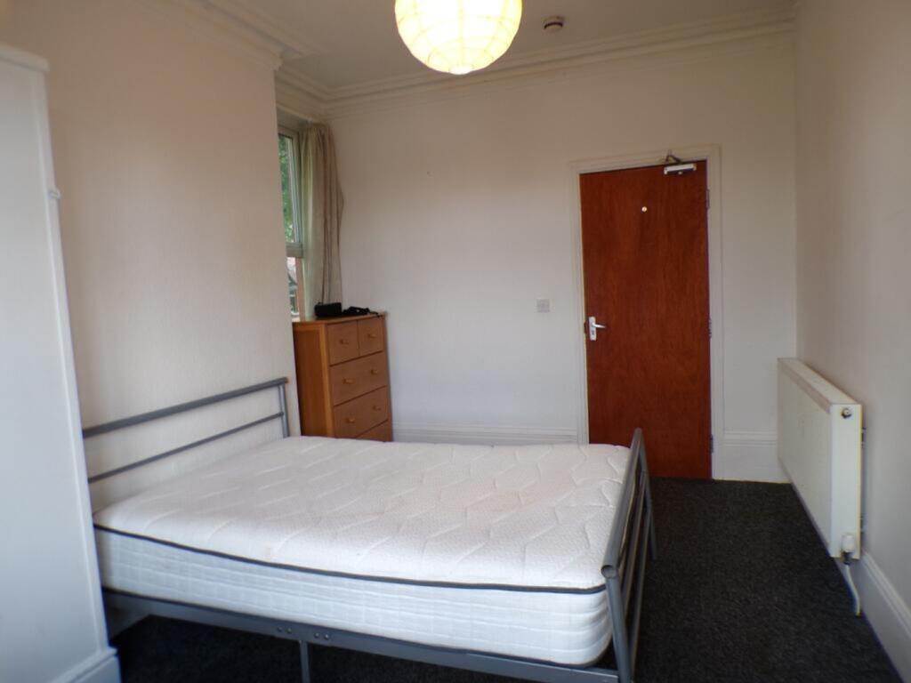 Spacious double bedroom featuring ample natural...