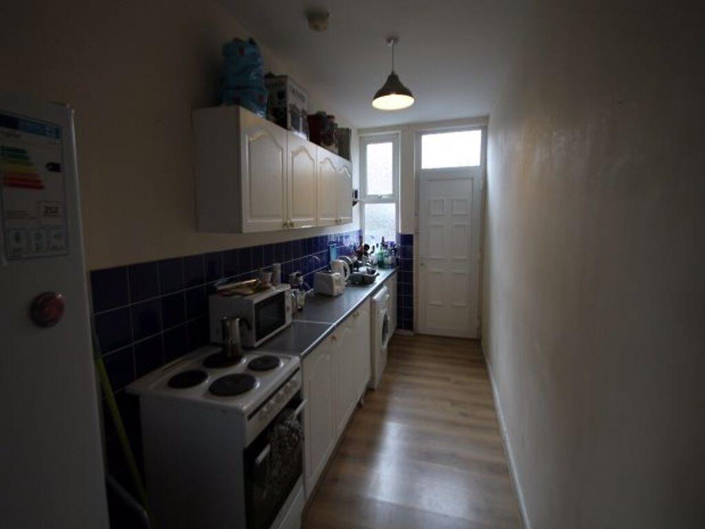 A compact kitchen with a neat arrangement of ap...