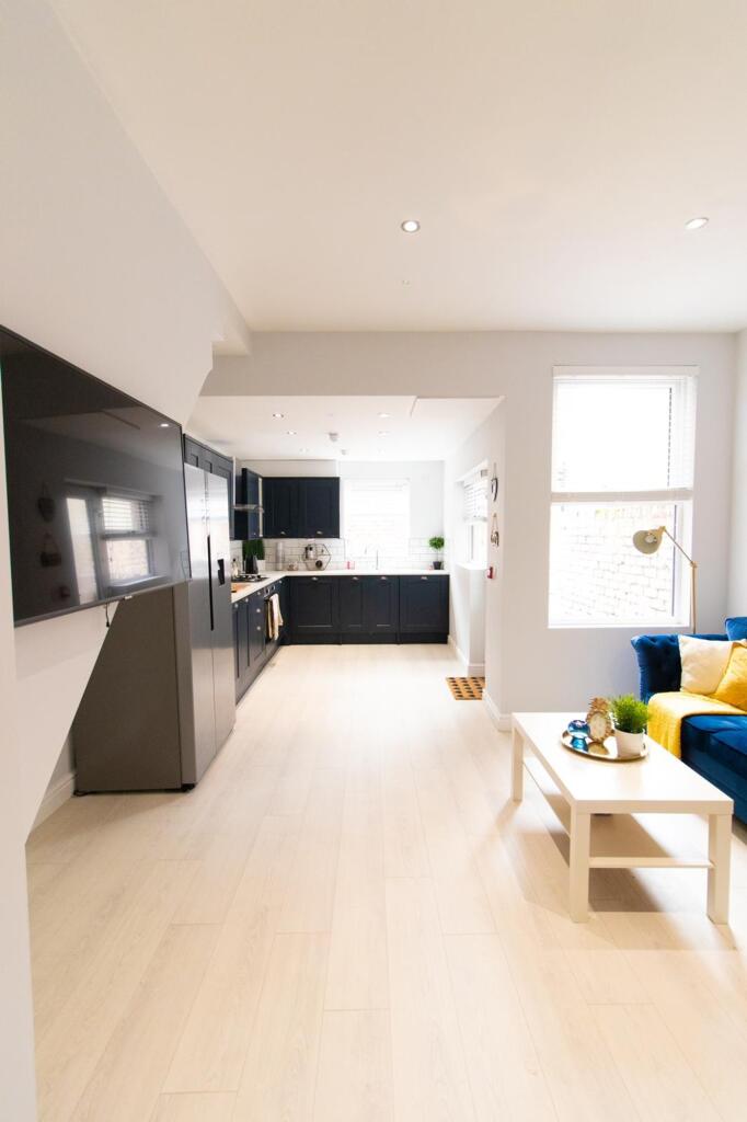 A spacious and modern living room with ample na...