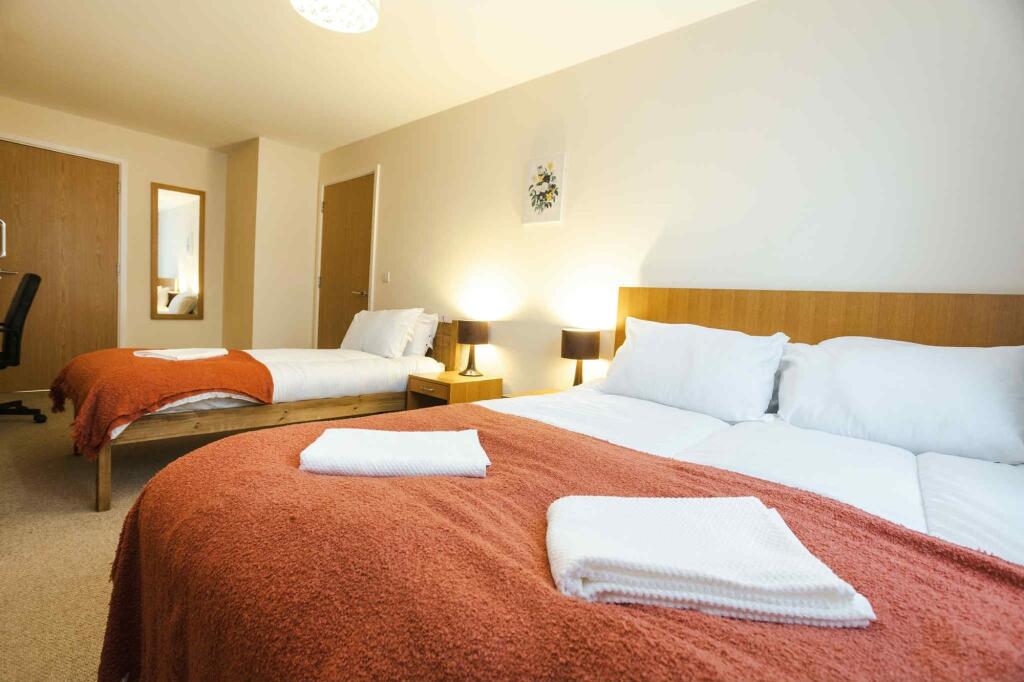Bright and inviting double bedroom featuring tw...