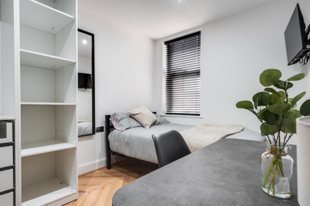 A bright and stylish double bedroom featuring m...