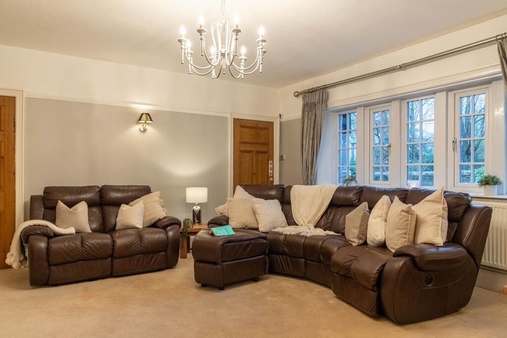 The main lounge on the front elevation with dual access doors to the entrance hall