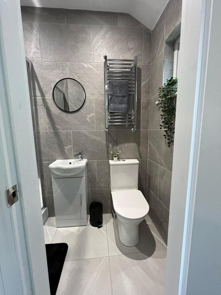 Modern bathroom featuring sleek tiles, a stylis...