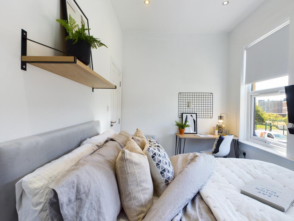 A bright and inviting double bedroom featuring ...