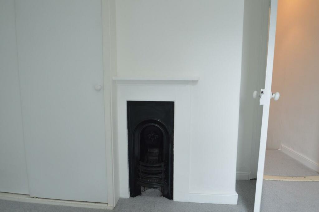 Bedroom one feature fire place.JPG
