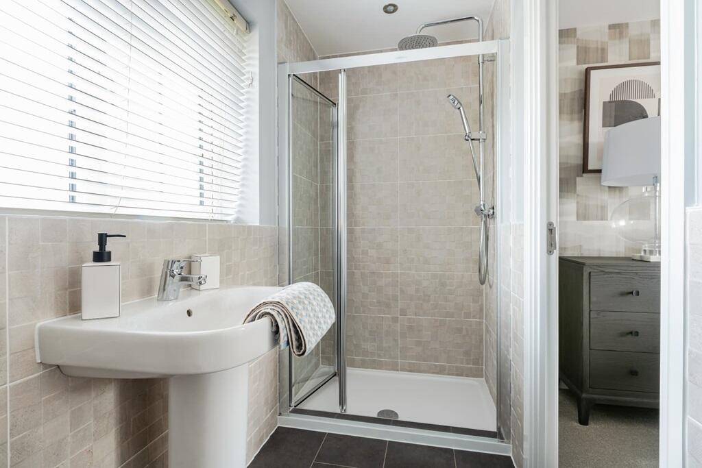 En suite to bedroom 1 with full width shower cubicle