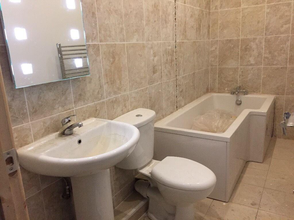 A clean and modern bathroom suite featuring a w...