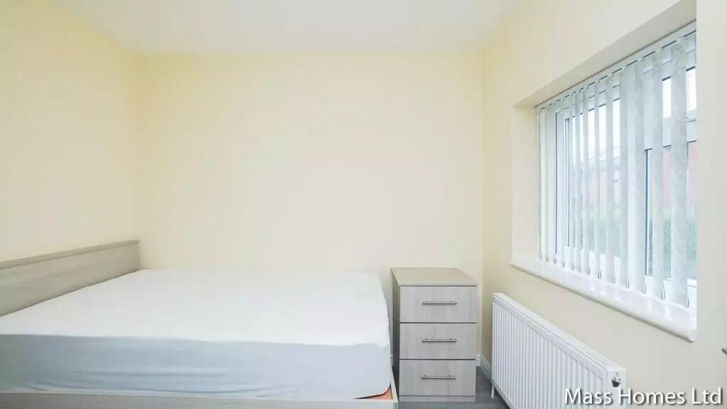 Bright and tidy double bedroom featuring a comf...