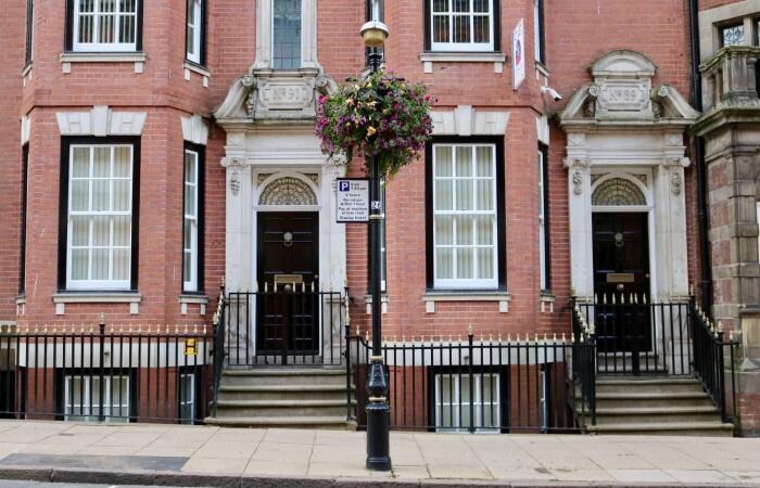 Elegant red-brick terraced house facade with cl...