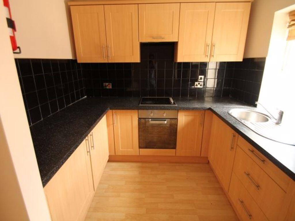 A neat and well-maintained kitchen with light w...