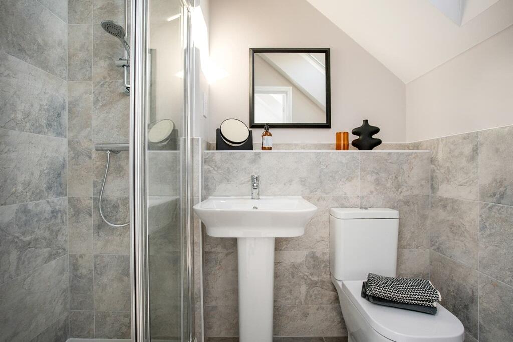 The ensuite benefits from a double shower enclosure