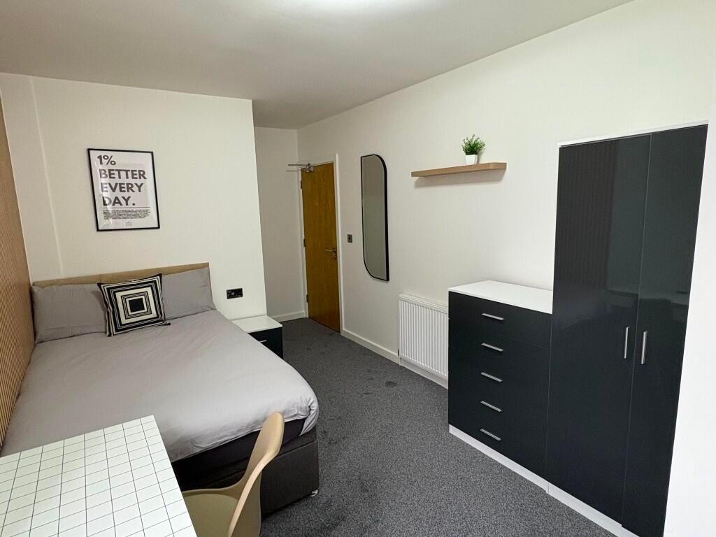 A neat and well-organized bedroom featuring a c...
