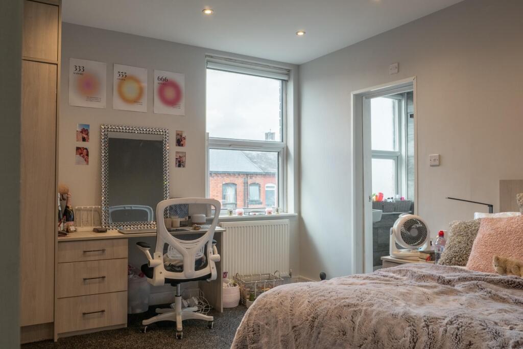 A bright and spacious master bedroom featuring ...