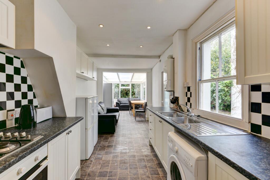 Bright and airy kitchen featuring a spacious la...