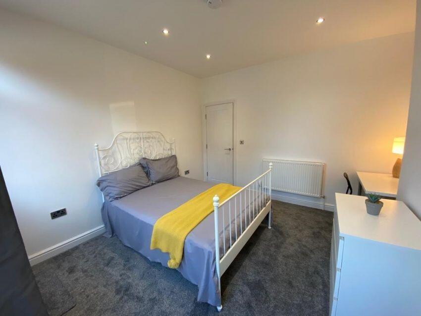 A bright and welcoming master bedroom featuring...