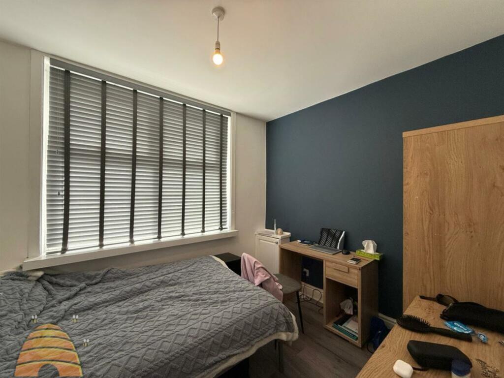 A cozy double bedroom with a modern touch, feat...