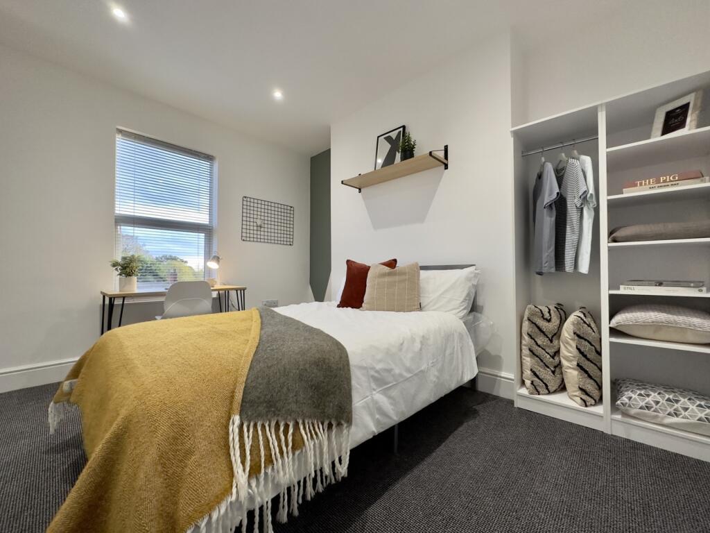 A bright and inviting double bedroom featuring ...