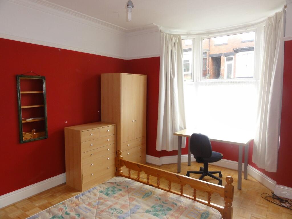 Bright and cheerful bedroom with bold red walls...