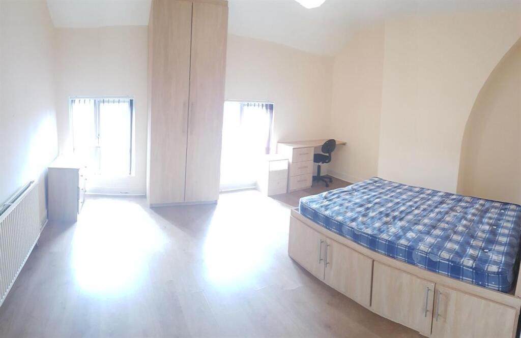 Bright and spacious double bedroom with a large...