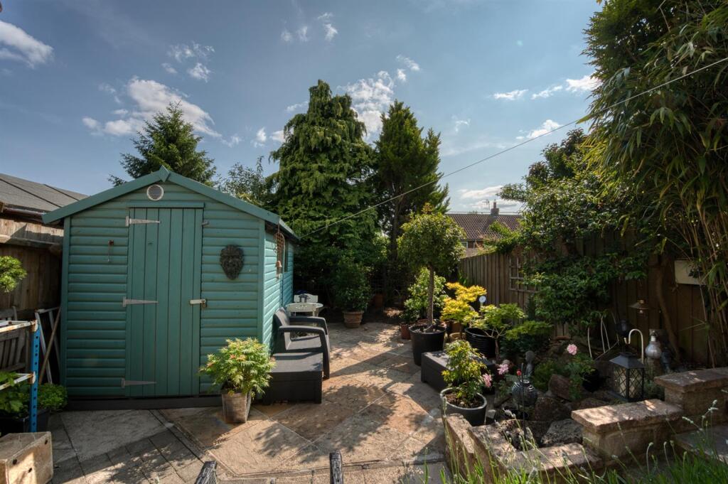 Rear Garden - large shed and planters.jpg