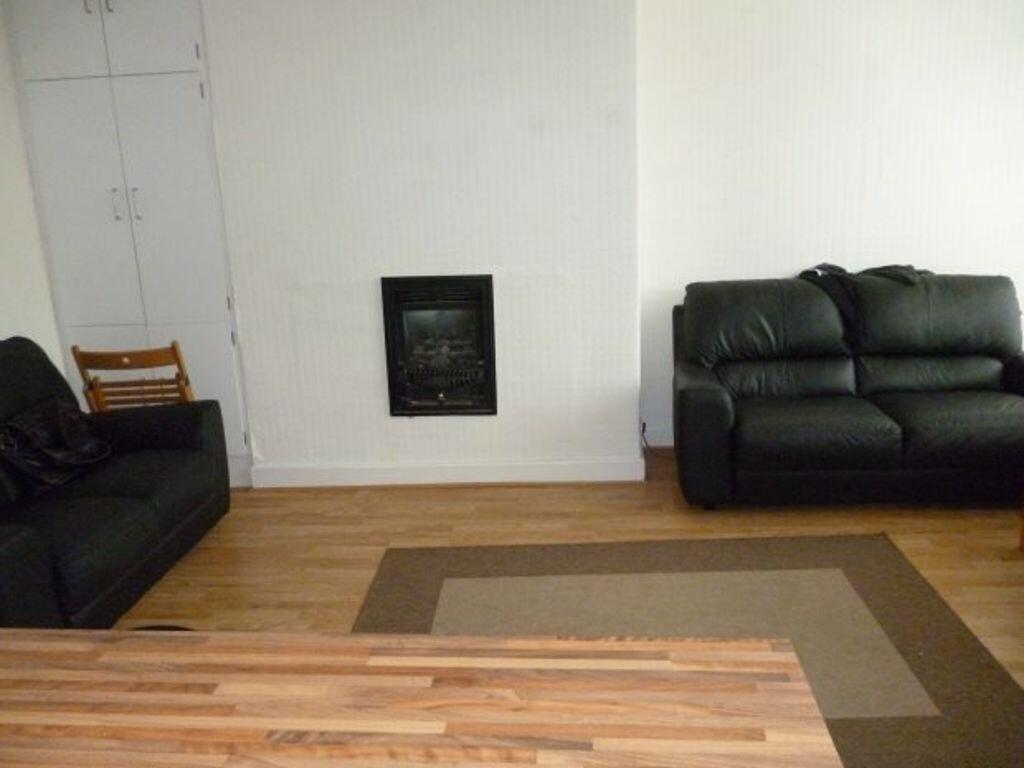 A comfortable living room featuring two black l...
